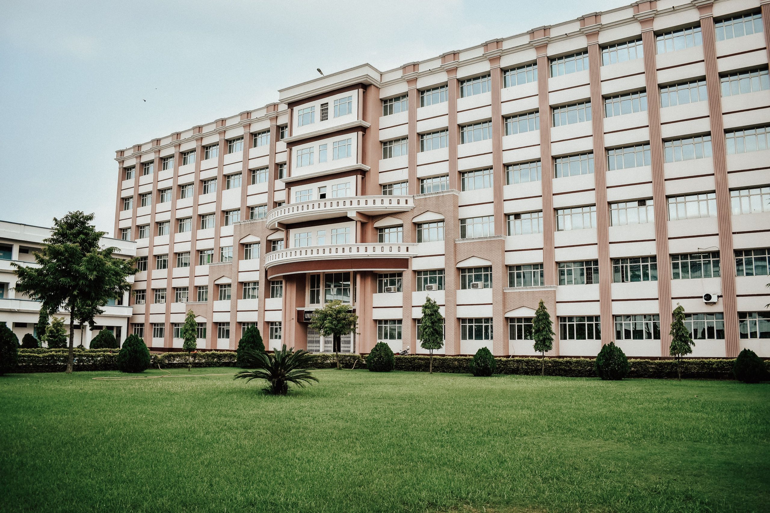 A modern school building with a landscaped lawn