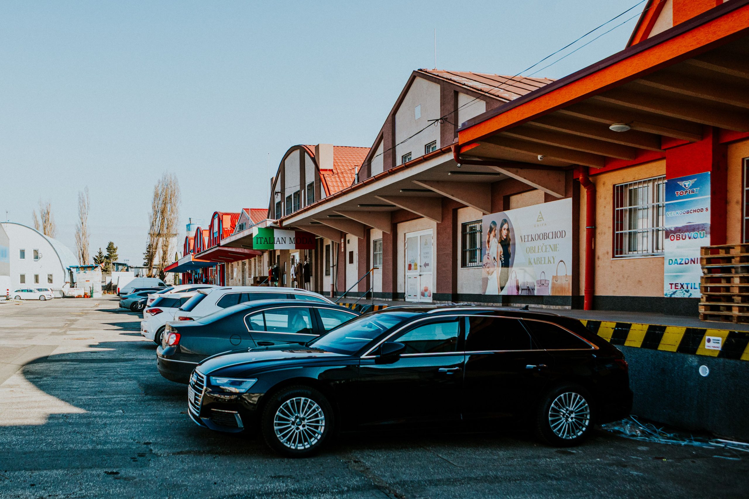 A shopping plaza parking lot with storefronts