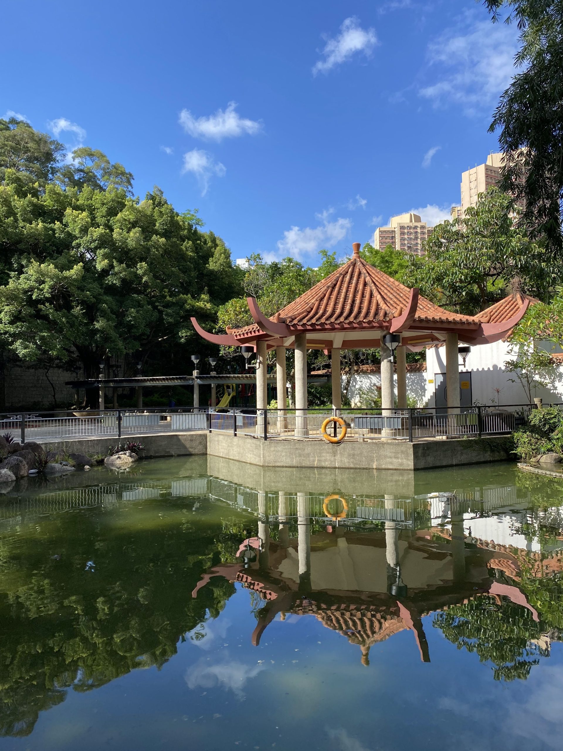 A park gazebo reflected in a pond