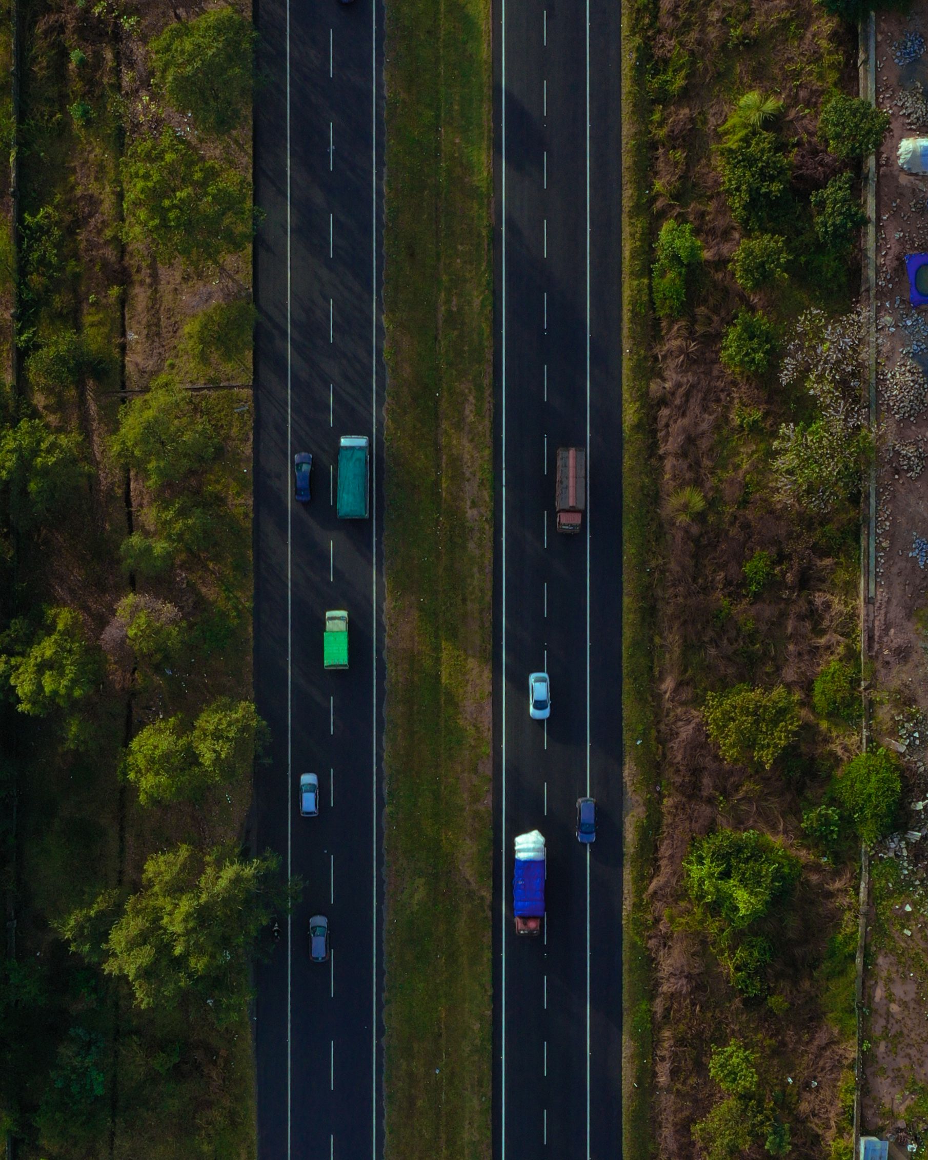 Aerial view of a divided highway through trees