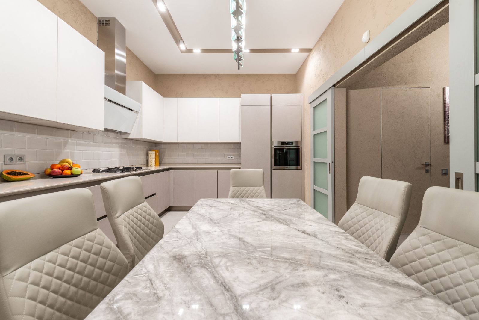 Refined kitchen and dining interior with marble table