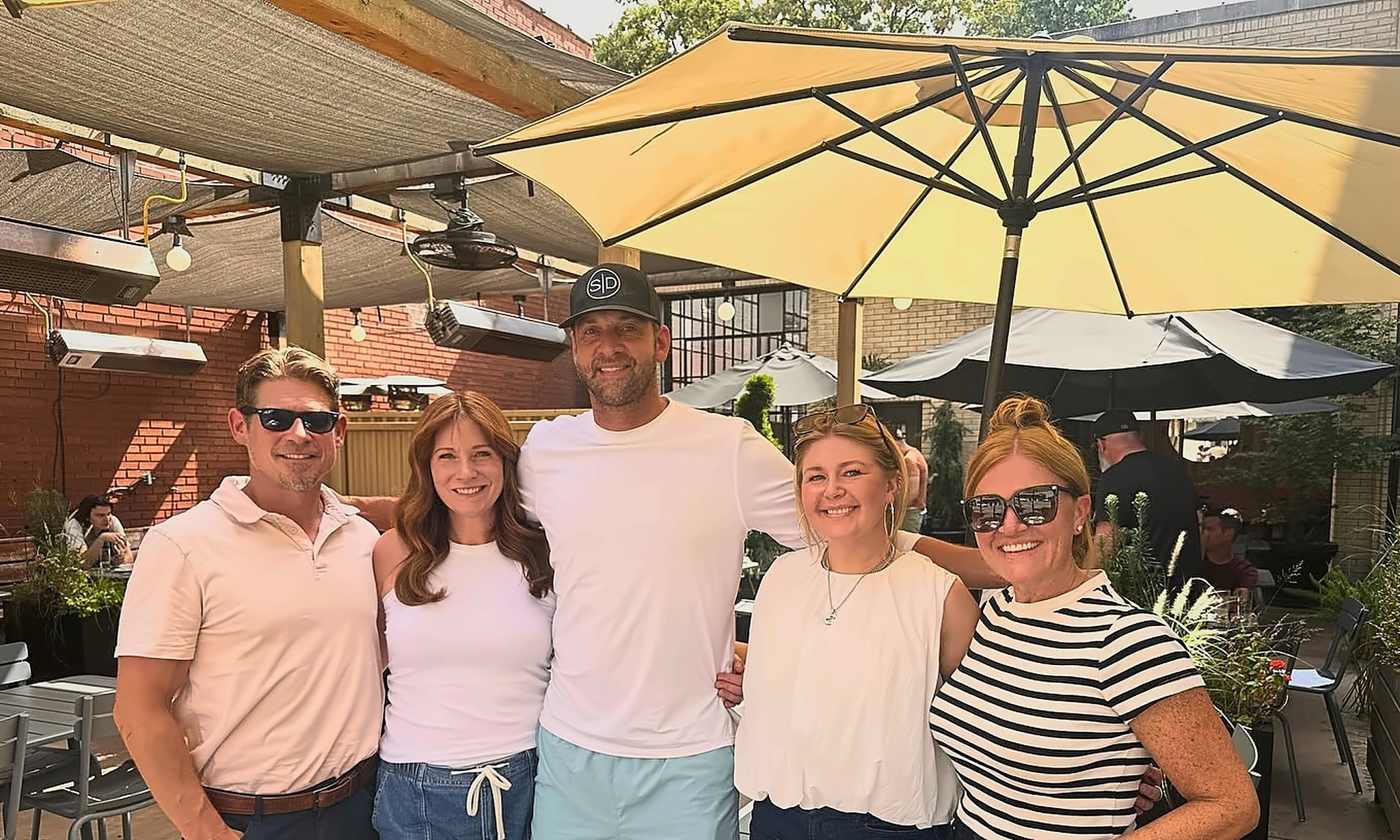 Coldwell Banker Premier Group agents gathered together on a sunny patio